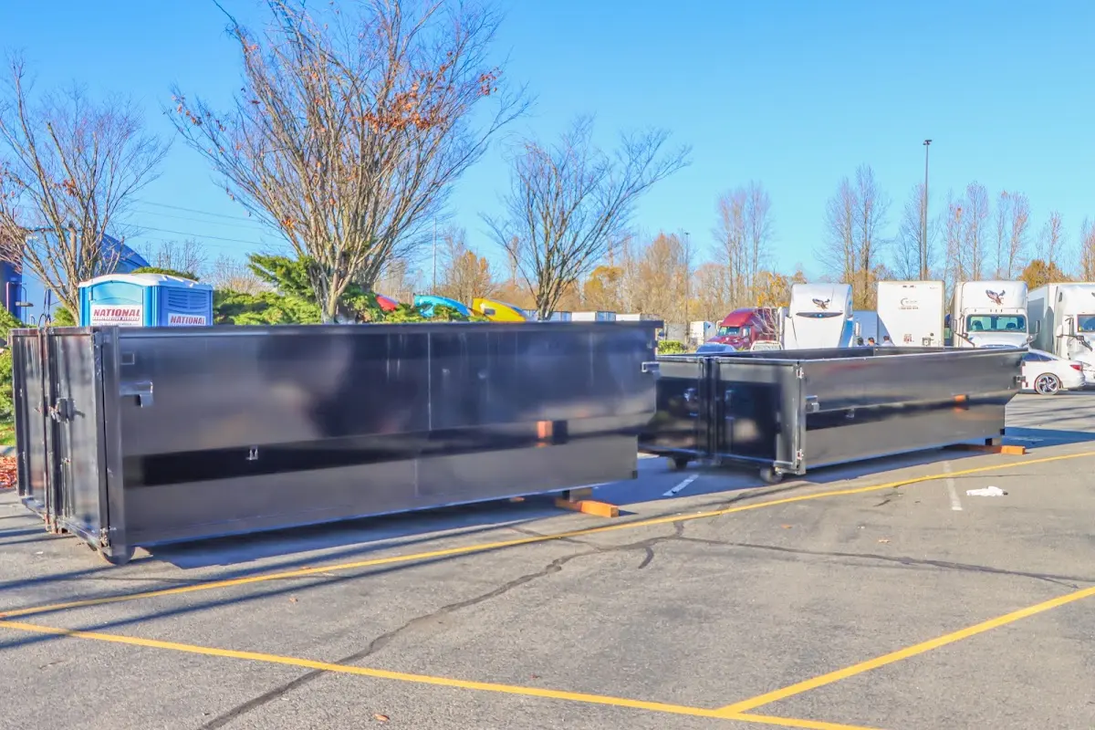 Professional dumpster rental service with roll-off container on residential driveway in DeLand